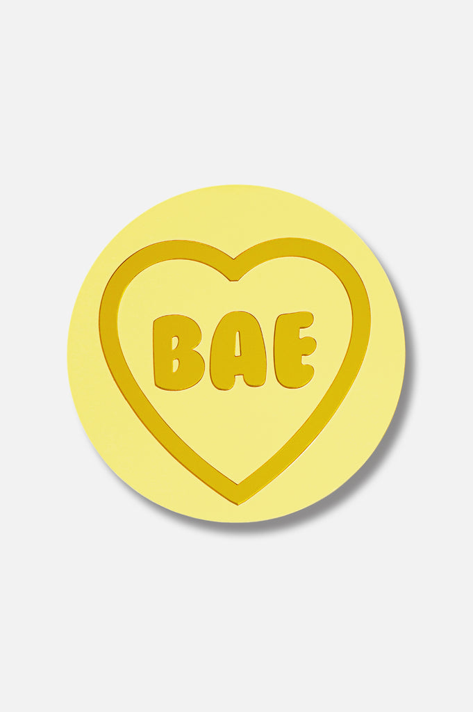 For individuals with visual impairment, 'Bea' is a tactile masterpiece of wall art inspired by classic Love Heart sweets. Dominated by a soothing yellow pastel hue, this piece features a central affectionate message 'Bae,' crafted with elegant gold outlines and additional tactile messages. As a unique addition to our Love collection, 'Bea' serves as a touchable wall decor, adding charm and warmth to your space while brightening the surroundings with love.