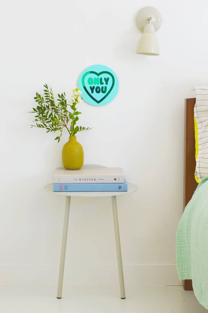 This image features the 'Only You' pastel hue acrylic Love Heart Sweet-inspired wall art. Hung on a serene neutral wall by a bedside table, the delicate pastel shades gently illuminate the space. The heart-shaped artwork, adorned with the words 'Only You,' adds a touch of warmth and affection to the bedside setting. This description aims to provide an accessible portrayal of the elegant pastel hues and heartfelt message conveyed by the artwork